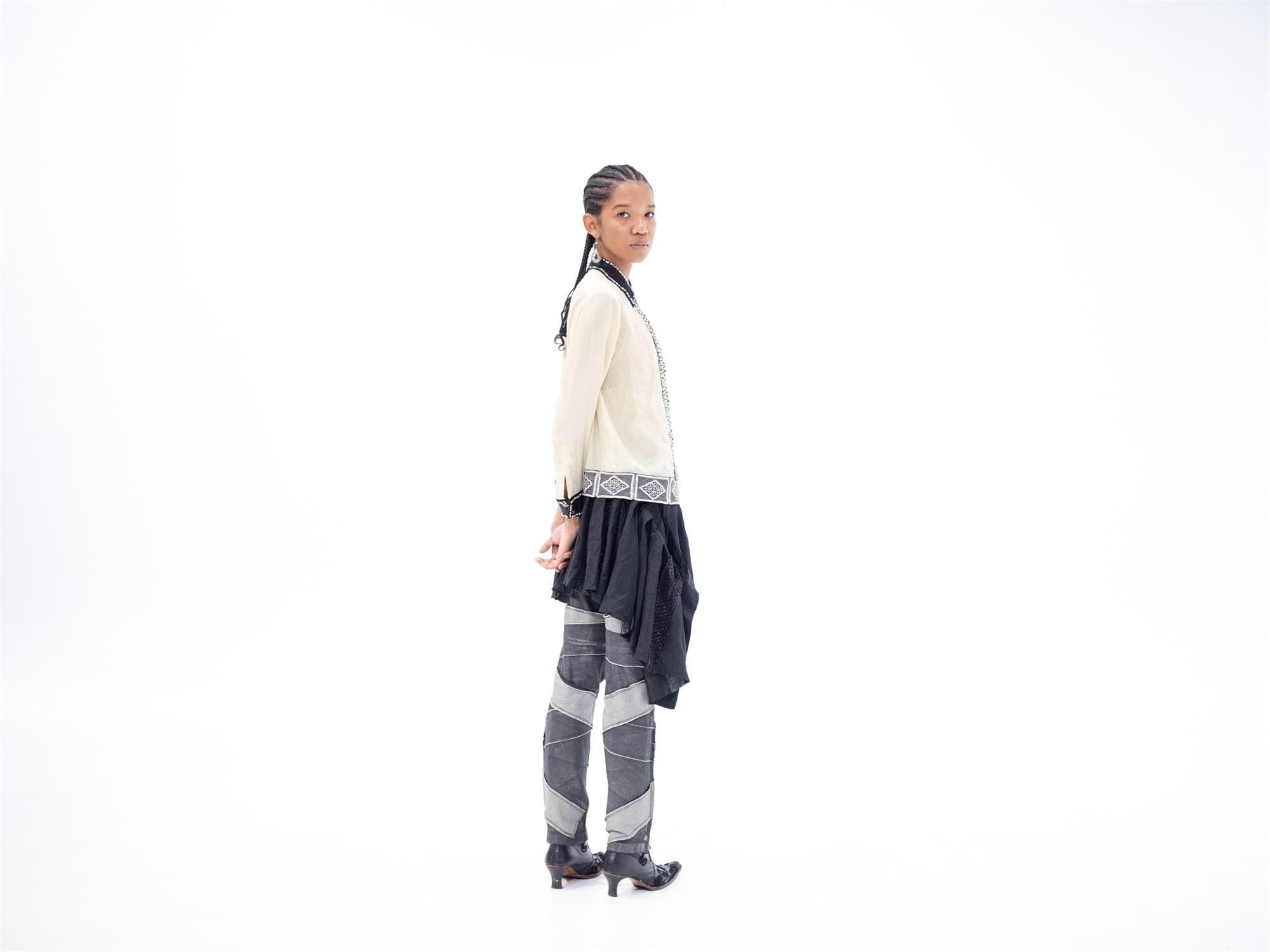 A model in a Dries Van Noten shirt with a Sacai skirt, photographed in studio